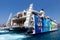 Tourists arriving to Santorini`s port from iOS on board catamaran super ferry.