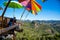 Tourists asian couple sitting eat noodle on the wooden platform and looking scenic view of beautiful nature mountains at Ban Jabo,