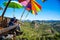 Tourists asian couple sitting eat noodle on the wooden platform and looking scenic view of beautiful nature mountains at Ban Jabo,