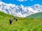 Tourists with a backpacks in Caucasus mountains. Svaneti region, Georgia