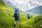 Tourists with backpacks on hiking trail walk along green hills in highlands. Hiking in mountains