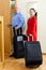 Tourists with baggage near door in home