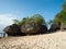 Tourists on Bali beach with rock formations