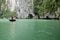 Tourists on bamboo boats touring around the islands and caves of ha long bay