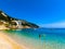 Tourists on beach Banje with Dubrovnik town in background, Croatia