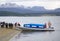 Tourists on the beach in the island in Beagle Channel, Argentina