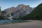 Tourists on the beach of Lake Braies with awesome dolomitic mountains background