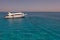 Tourists boat anchored in a bay for snorkeling