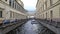 Tourists boat cruising at the narrow channel of Neva river near Hermitage in Saint Petersburg