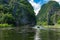 Tourists in a boat exploring the scenery Ngo Dong River. Beautiful scenery, cliffs and river