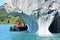 Tourists in a boat in front of Capillas de MÃ¡rmol rock formations, Chile