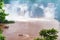 Tourists boat running in the Iguazu River in front of the beautiful Iguazu Falls