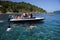 Tourists in a boat, taking pictures of sea turtles, snorkeling