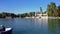 Tourists on boats in Parque del Buen Retiro lake on a sunny day in Madrid, Spain.