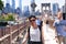 Tourists on the Brooklyn bridge and New York City Skyline daytime