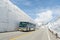 Tourists bus move along the japan alps snow wall at tateyama kurobe alpine route