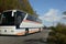 Tourists bus on narrowed mountain high way.