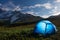 Tourists camp in mountains at night. Hikers tent in night mountain valley