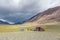 Tourists camping in Mongolian hills. Three tents under the open cloudy sky