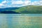 Tourists on canoe on calm blue Loch Lomond lake in Luss, Scotland, 21 July, 2016