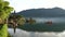 Tourists in a canoe photograph pura danu bratan temple on the island of bali