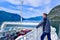 Tourists and cars on a ferry boat, crossing the Sognefjord in Norway