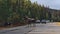 Tourists in cars on Maligne Lake Road observing big male moose with enormous antlers on the street in the Rocky Mountains.