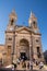 Tourists at the Cathedral of the SS Medici of Alberobello on a b