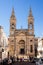 Tourists at the Cathedral of the SS Medici of Alberobello on a b