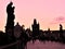 Tourists on the Charles Bridge at dawn. Silhouettes of medieval buildings