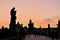 Tourists on the Charles Bridge at dawn. Silhouettes of medieval buildings