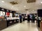 Tourists check luxury watches and perfumes at duty free store, Paris, France