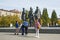 Tourists from China taking pictures at the background of the sculpture of Lenin and the Novosibirsk state academic Opera and ball