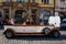 Tourists at a city tour on a beautiful antique car at old town square in Prague