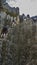 Tourists climb the cliff with safety equipment.