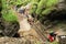 Tourists climbing iron ladders in Slovak Paradise