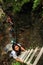 Tourists climbing iron ladders in Slovak Paradise