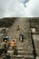Tourists Climbing Mayan High Temple in Lamanai, Belize
