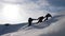 Tourists climbing a mountain snow cliff. Stretching a helping hand. People help each other. Teamwork, teamwork concept