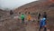 Tourists climbing the slope heading to the Jose Rivas refuge located at 4800 meters in the volcano Cotopaxi