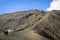 Tourists climbing stairway to the rim of Mount Bromo