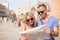 Tourists couple looking at city map