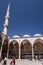 Tourists in the courtyard of the Blue Mosque, historic mosque located in Istanbul, Turkey. A popular tourist site