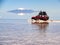 Tourists cross the flooded Salar de Uyuni. Uyuni, Bolivia