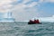 Tourists from cruise liner in zodiac in front of huge icebergs in Antarctia, Point Wild, Elephant Island