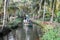 Tourists cruising on a canoe a river of the backwaters at Kollam