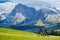 Tourists cycling in Seiser Alm, the largest high altitude Alpine meadow in Europe, stunning rocky mountains on the background