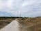 Tourists cycling towards the lighthouse