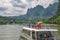 Tourists on a deck of a boat sailing on a Li River in China