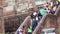 Tourists descend the stone stairs to the ancient Buddhist buildings